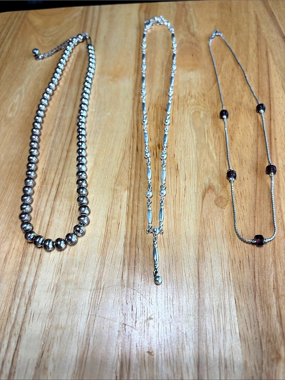 Three silver tone necklaces-costume jewelry